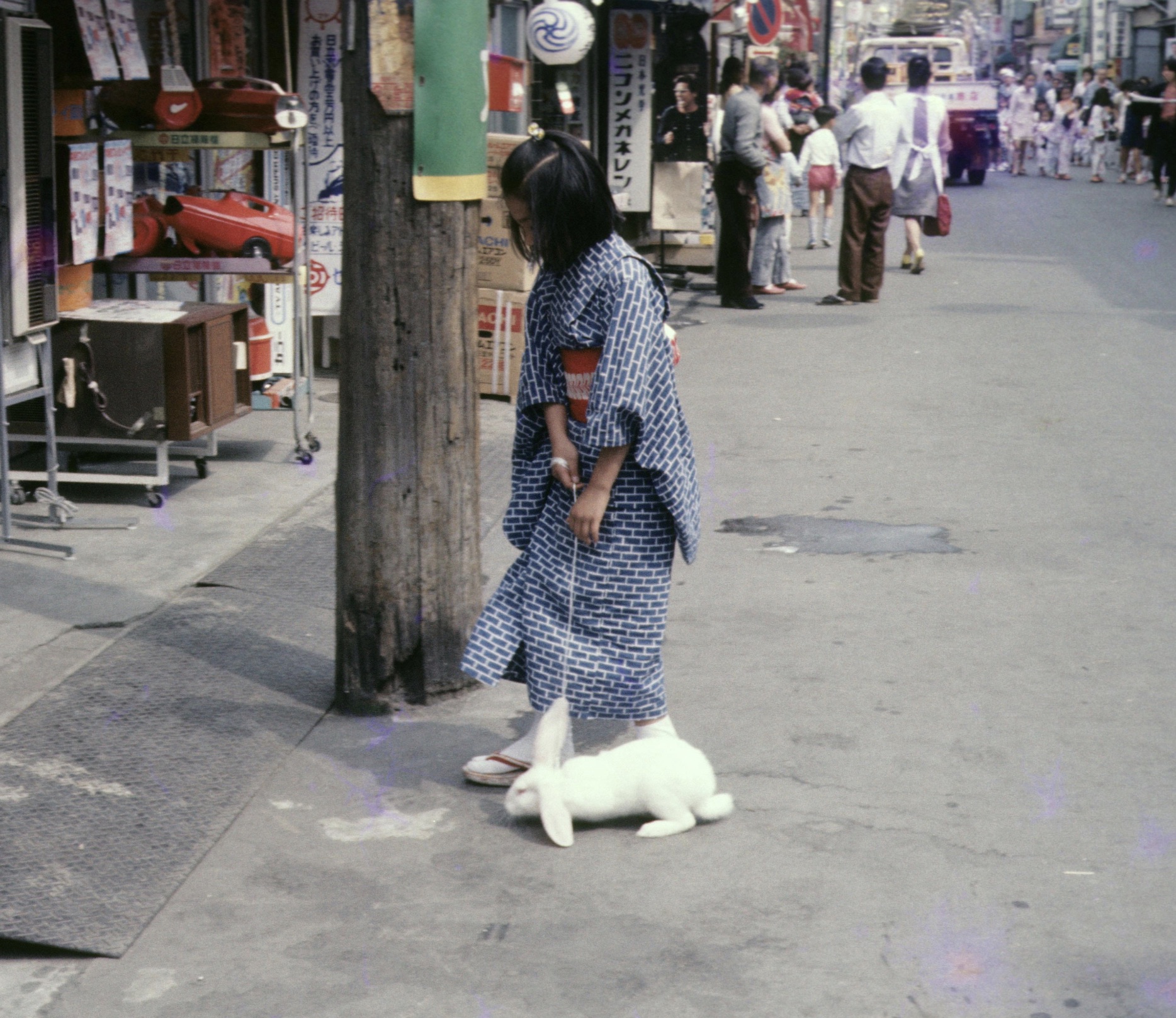 A girl walking her rabbit in a summer kimono. Shinagawa, Japan, 1973. 